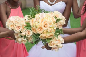 Black,African,American,Bride,And,Bridesmaids,Holding,Bouquets,Of,Peach